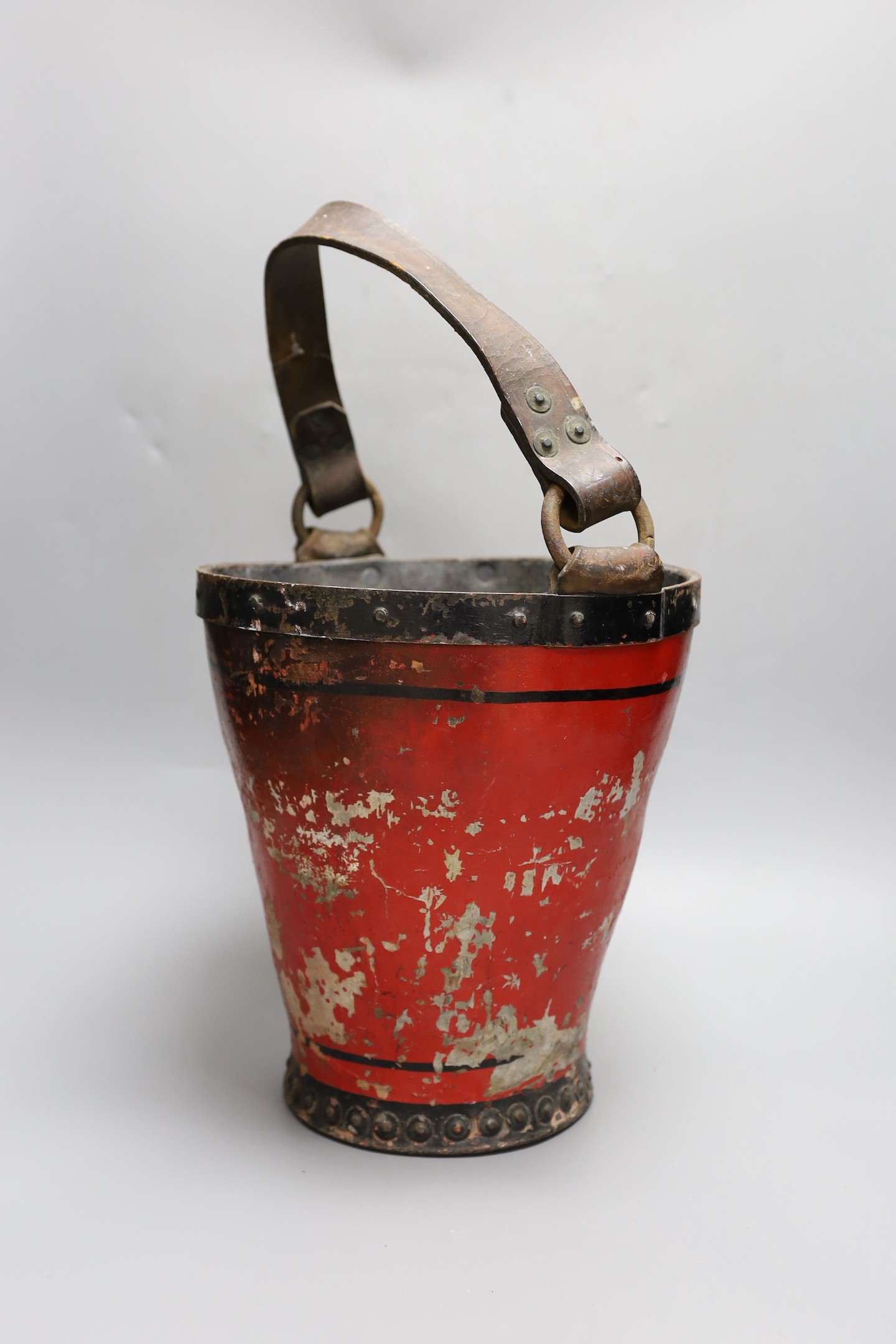 A 19th century iron bound painted leather fire bucket together with a small kukri knife